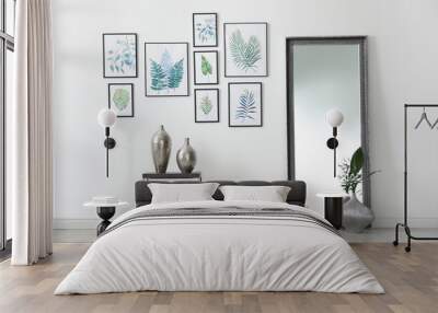 Living room interior with paintings of tropical leaves on white wall Wall mural