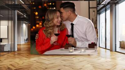 Lovely couple having romantic dinner on Valentine's day in restaurant Wall mural