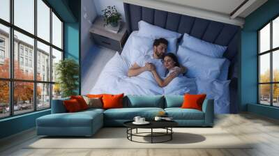 Lovely couple sleeping together in bed at night, top view Wall mural