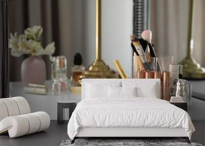 Luxury makeup products and accessories on dressing table with mirror. Space for text Wall mural