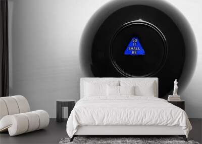 Magic eight ball with prediction So It Shall Be on white table, closeup. Space for text Wall mural