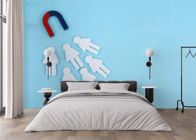 Magnet attracting paper people on light blue background, flat lay. Space for text Wall mural