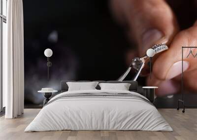 Male jeweler examining diamond ring in workshop, closeup view Wall mural