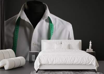 Male mannequin with white shirt and measuring tape on grey background. Space for text Wall mural