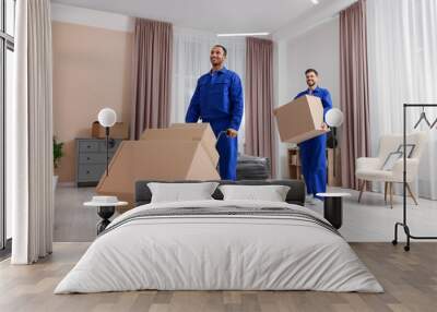 Male movers with cardboard boxes in new house Wall mural