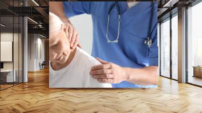 Male orthopedist examining patient with injured neck, closeup Wall mural