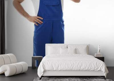 Male worker with rolled carpet on white background Wall mural