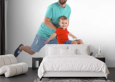 Man and his son playing with suitcase on white background. Vacation travel Wall mural