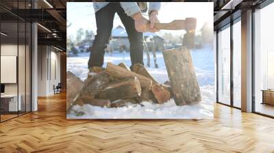 Man chopping wood with axe outdoors on winter day, closeup Wall mural