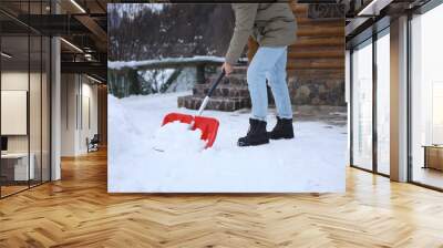 Man cleaning snow with shovel outdoors on winter day, closeup Wall mural