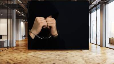 Man detained in handcuffs against dark background, space for text. Criminal law Wall mural