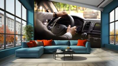 Man driving his car, closeup view of hands on steering wheel Wall mural