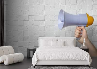 Man holding megaphone near white wall Wall mural