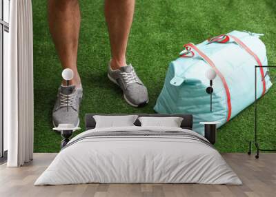 Man standing with sports bag, closeup view Wall mural