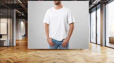 Man wearing white t-shirt on gray background, closeup Wall mural