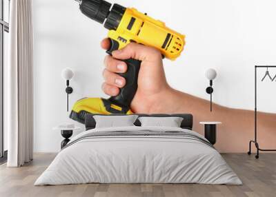 Man with cordless electric drill on white background, closeup Wall mural