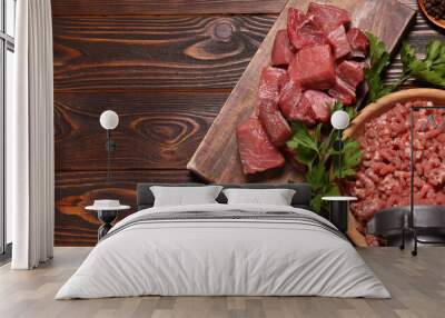 Manual meat grinder, beef, peppercorns and parsley on wooden table, flat lay. Banner design with space for text Wall mural