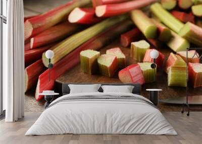 Many cut rhubarb stalks on wooden table, closeup Wall mural