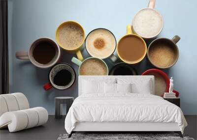 Many different cups with aromatic coffee on light blue table, flat lay Wall mural