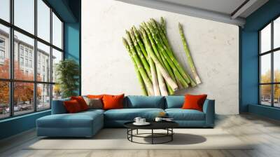 Many fresh green asparagus stems on light textured table, top view Wall mural