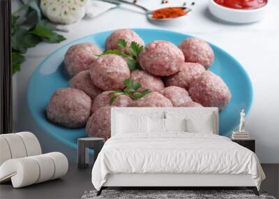 Many fresh raw meatballs on white table Wall mural