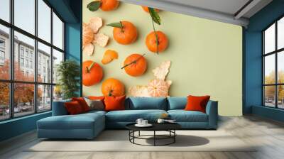 Many fresh ripe tangerines and leaves on light green table, flat lay. Space for text Wall mural