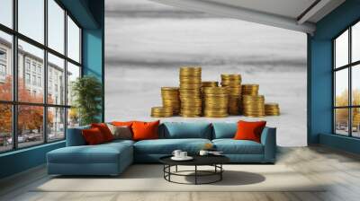 Many stacks of coins on table color background Wall mural