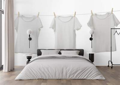 Many t-shirts drying on washing line isolated on white Wall mural