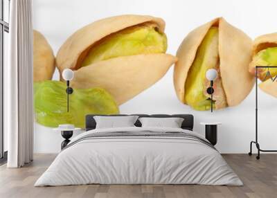 Many tasty pistachio nuts isolated on white Wall mural