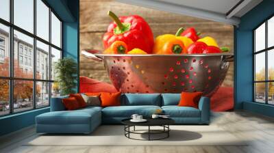 Metal colander with fresh peppers on table, closeup Wall mural