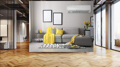 Modern air conditioner on light grey wall in living room with stylish sofa Wall mural