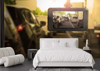 Modern dashboard camera mounted in car, view of road during driving Wall mural