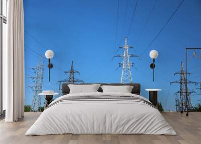 Modern high voltage towers against blue sky Wall mural