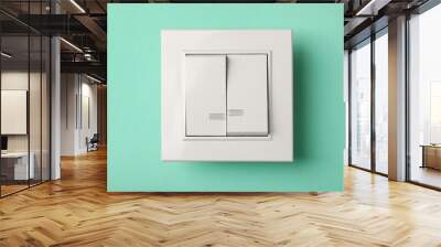 Modern plastic light switch on turquoise background Wall mural