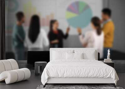 Modern video projector and blurred people on background Wall mural