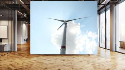 Modern wind turbine against blue sky, low angle view. Energy efficiency Wall mural