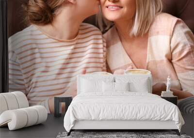 Mother and her adult daughter spending time together in cafe, closeup Wall mural