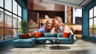 Mother and her adult daughter spending time together in cafe Wall mural