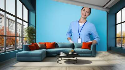 Nurse in medical uniform on light blue background, space for text Wall mural