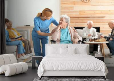 Nurses assisting elderly people at retirement home Wall mural