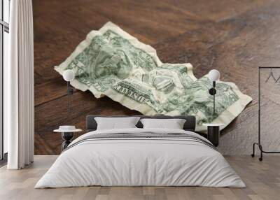 One crumpled dollar banknote on wooden table, closeup Wall mural