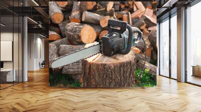 One modern saw on wooden log outdoors Wall mural