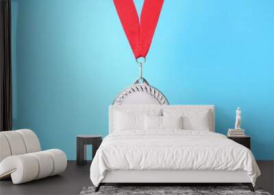 One silver medal with ribbon on light blue background Wall mural