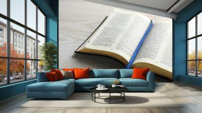 Open Bible on white wooden table. Christian religious book Wall mural