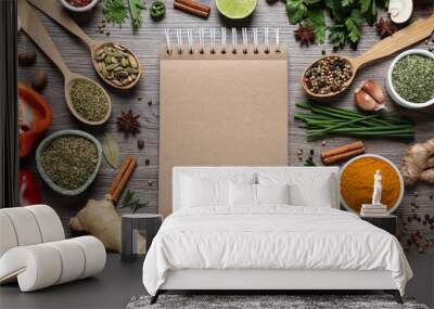 Open recipe book and different ingredients on wooden table, flat lay. Space for text Wall mural