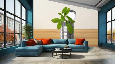 Organic houseplant in tin can on wooden table Wall mural