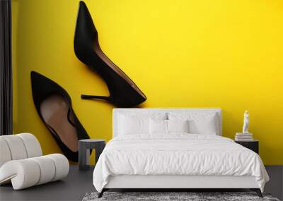 Pair of elegant black high heel shoes on yellow background, flat lay. Space for text Wall mural