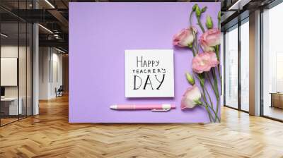 Paper with inscription HAPPY TEACHER'S DAY and flowers on violet background, flat lay. Space for text Wall mural