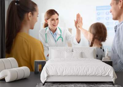 Parents with little daughter visiting children's doctor in hospital Wall mural