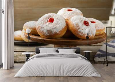 pastry stand with delicious jelly donuts on wooden table Wall mural